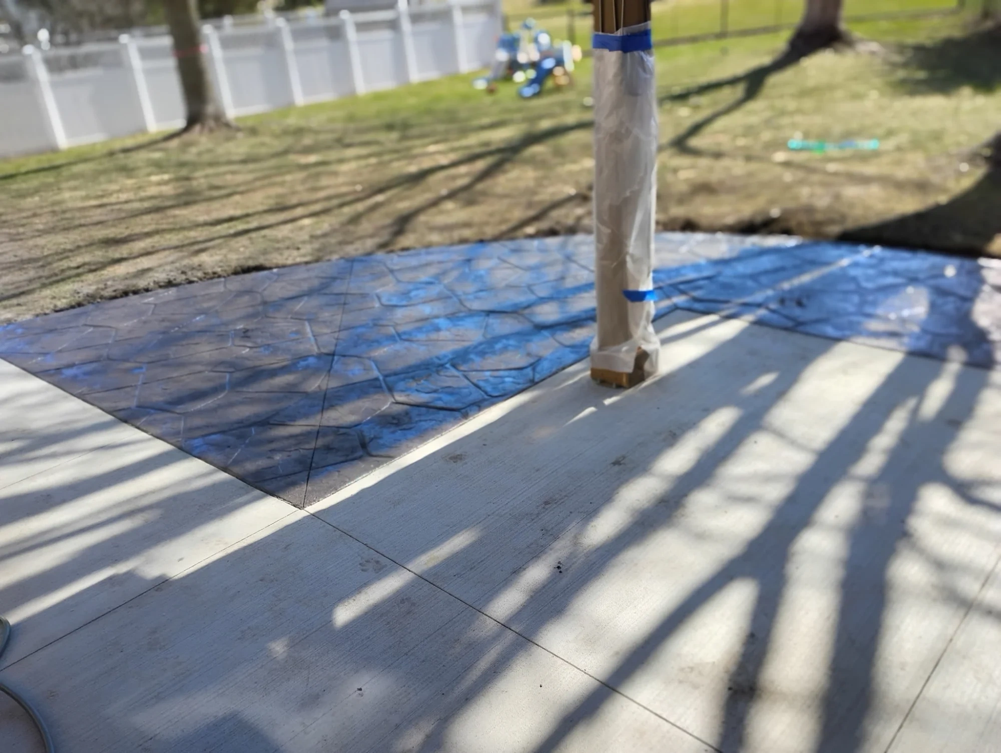 Fresh concrete pour curing under blue tarp in southern Minnesota