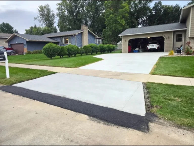 Concrete driveway apron viewed at an angle from the street in Owatonna