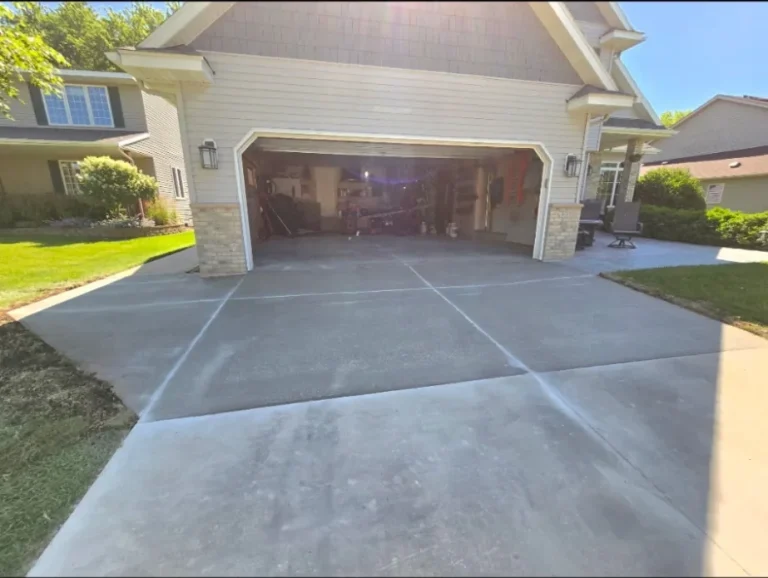 Large concrete driveway at a brick home on a sunny day in Minnesota