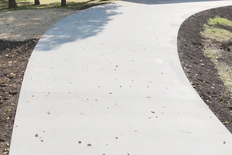 Long white concrete driveway leading to a detached garage in southern Minnesota