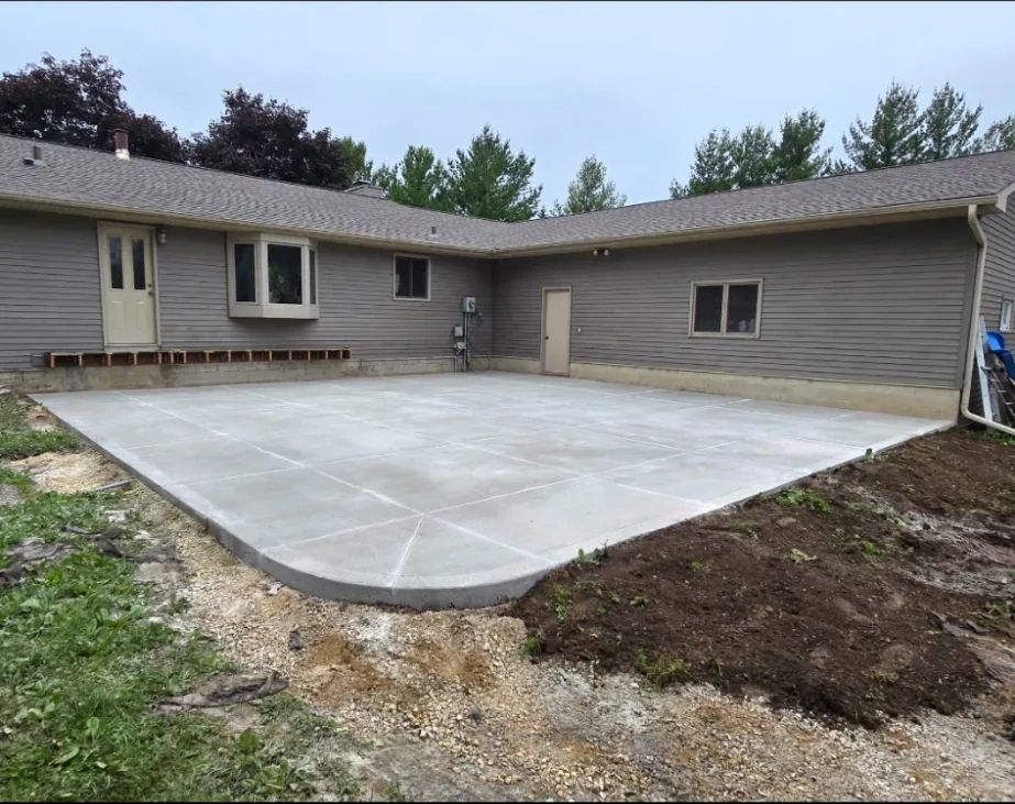 Large finished concrete back patio beside a ranch home, Owatonna