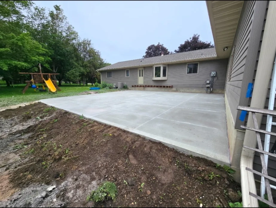 Concrete side-yard patio beside a residential home in Owatonna